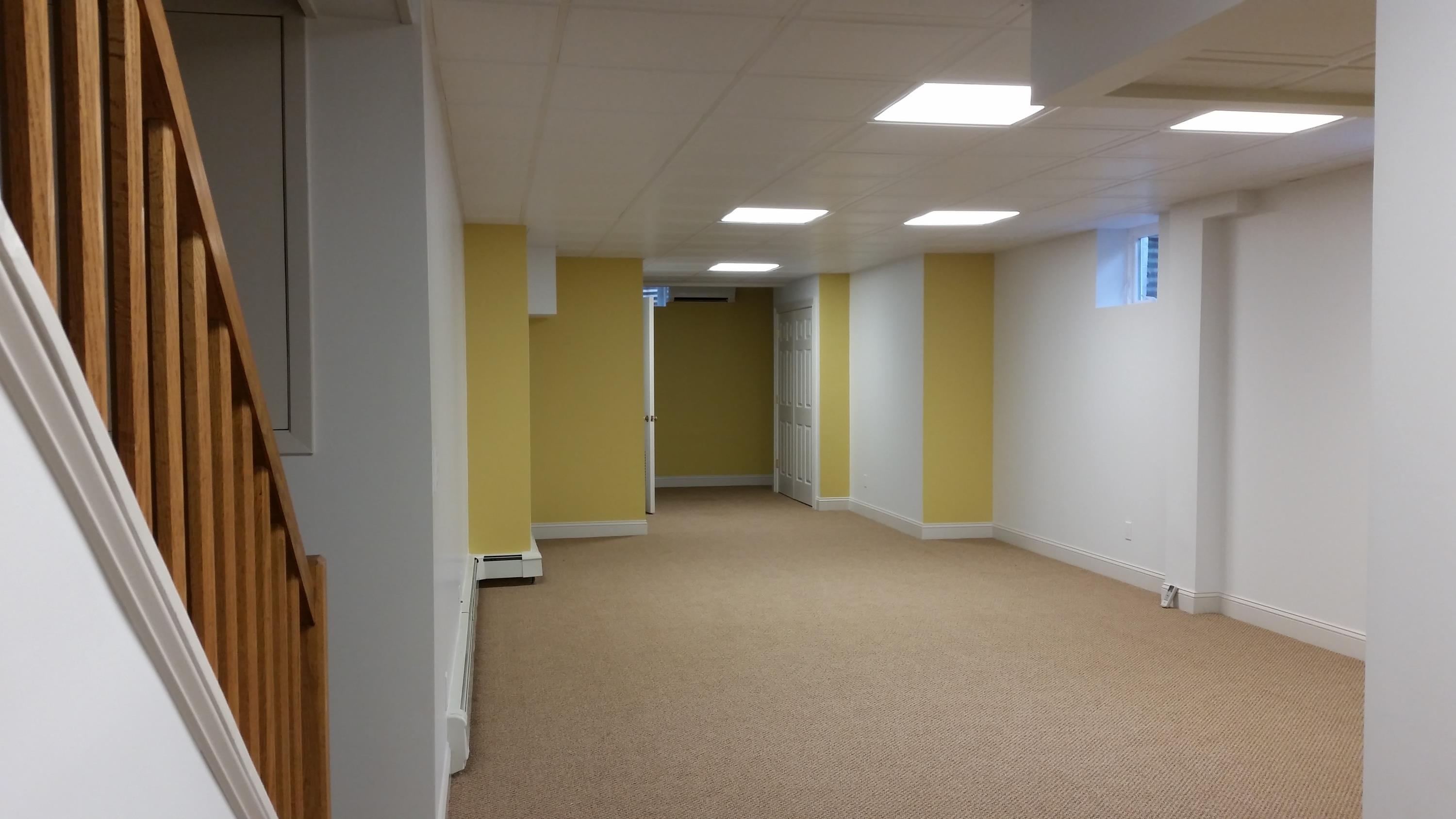 Newly renovated basement with brown carpeting